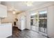 Kitchen with white cabinets, refrigerator, and patio access at 1289 S Monaco Pkwy, Denver, CO 80224