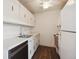Efficient kitchen featuring white cabinets and modern appliances at 1289 S Monaco Pkwy, Denver, CO 80224