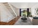 Living room with hardwood floors, staircase, and neutral decor at 1289 S Monaco Pkwy, Denver, CO 80224