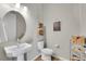 Small bathroom with pedestal sink and toilet at 16439 Arrow Peak Way, Broomfield, CO 80023