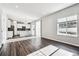 Open concept living and dining area with wood-look flooring, view of the kitchen, and a window at 18228 Martinello Dr, Parker, CO 80134