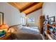 Bedroom with bed, wood floors, and built-in shelves at 6597 S State Highway 83, Franktown, CO 80116