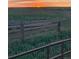Green corral with wooden posts against a sunset at 6597 S State Highway 83, Franktown, CO 80116
