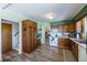 Kitchen with wood cabinets, white appliances, and flooring at 6597 S State Highway 83, Franktown, CO 80116