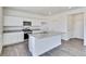 Modern kitchen with white cabinets, granite countertops, and island at 18837 E 99Th Ave, Commerce City, CO 80022