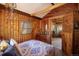 Charming bedroom with wood walls, access to another room, and a calm atmosphere at 80 Outlook Dr, Golden, CO 80403