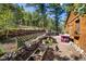 Charming patio area with stone wall, flowers, and wooden bench at 80 Outlook Dr, Golden, CO 80403