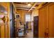 Small office with wood-paneled walls, a desk, and built-in storage at 80 Outlook Dr, Golden, CO 80403