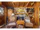 Charming living room with stone fireplace, wood paneling, and comfy seating at 80 Outlook Dr, Golden, CO 80403