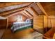 Cozy loft bedroom with wood-beamed ceiling, a dresser, and a window offering natural light at 80 Outlook Dr, Golden, CO 80403