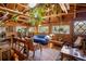 Open living room with wood-beamed ceiling, wood walls, and ample natural light at 80 Outlook Dr, Golden, CO 80403