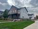 Modern townhome with gray siding, covered porch, and well-maintained lawn at 11137 E 25Th Ave, Aurora, CO 80010