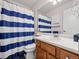 Clean bathroom with blue and white striped shower curtain at 3873 S Halifax St, Aurora, CO 80013