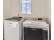 Bright laundry room with Maytag washer and dryer at 1269 E Hopkins Dr, Elizabeth, CO 80107