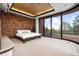 Main bedroom with stone wall and private balcony at 30786 Snowbird Ln, Evergreen, CO 80439