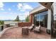 Stone patio with seating area and mountain views at 30786 Snowbird Ln, Evergreen, CO 80439