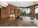 Elegant dining room with a stone accent wall and large windows at 30786 Snowbird Ln, Evergreen, CO 80439