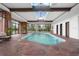 Indoor pool with stone flooring and skylights at 30786 Snowbird Ln, Evergreen, CO 80439