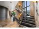 Modern staircase with metal railing and wood steps, offering ample natural light at 30786 Snowbird Ln, Evergreen, CO 80439