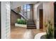 Bright entryway with a modern staircase and glass block feature wall at 30786 Snowbird Ln, Evergreen, CO 80439
