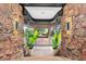 Grand entryway with stone walls, large windows, and lush potted plants at 30786 Snowbird Ln, Evergreen, CO 80439
