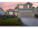 Two-story house with gray siding, stone accents, and a landscaped lawn at 1851 Lochmore Dr, Longmont, CO 80504