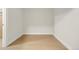 Empty basement room with light wood flooring at 3955 S Uinta St, Denver, CO 80237