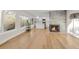 Open concept living room with hardwood floors and kitchen view at 3955 S Uinta St, Denver, CO 80237