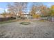 Large backyard with mature trees, shed, and a spacious grassy area at 3955 S Uinta St, Denver, CO 80237