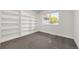 Bright bedroom with built-in shelving and grey carpeting at 3955 S Uinta St, Denver, CO 80237