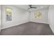 Spacious bedroom with ceiling fan and grey carpet at 3955 S Uinta St, Denver, CO 80237