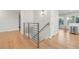 Modern stairwell with metal railing and light wood floors at 3955 S Uinta St, Denver, CO 80237
