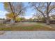 Large backyard perfect for outdoor activities, with mature trees and a shed at 3955 S Uinta St, Denver, CO 80237