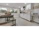 Basement kitchenette with white cabinets and countertop at 3955 S Uinta St, Denver, CO 80237