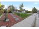 Landscaped front yard with walkway to the house at 3955 S Uinta St, Denver, CO 80237