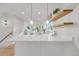 Modern kitchen island with white quartz countertop and pendant lighting at 3955 S Uinta St, Denver, CO 80237