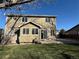 Backyard view of two-story house and patio at 13031 Dexter St, Thornton, CO 80241