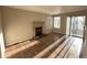 Living room with fireplace and sliding glass door to patio at 13031 Dexter St, Thornton, CO 80241
