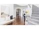 Bright entryway with hardwood floors, bench, and view of staircase and main bedroom at 10182 Stoneridge Ter, Parker, CO 80134