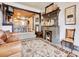 Living area with a fireplace and view into kitchen area at 3611-3615 Osage St, Denver, CO 80211