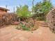 Landscaped backyard with flagstone patio and mature plants at 3611-3615 Osage St, Denver, CO 80211