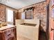 Rustic bathroom with exposed brick and copper tub at 3611-3615 Osage St, Denver, CO 80211