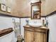 Elegant powder room with a pedestal sink and rustic wooden vanity at 3611-3615 Osage St, Denver, CO 80211