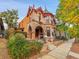 Victorian-style home with unique stonework, arched entryways, and beautiful landscaping at 3611-3615 Osage St, Denver, CO 80211
