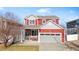 Two-story red brick home with a two-car garage and front porch at 19103 E 53Rd Ave, Denver, CO 80249