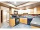 Well-equipped basement kitchen with wood cabinets and black appliances at 6183 Buffalo Run, Littleton, CO 80125