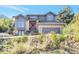 Two story home with gray siding and red door at 6183 Buffalo Run, Littleton, CO 80125