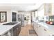 Modern kitchen with white cabinetry, large island, and stainless steel appliances at 6183 Buffalo Run, Littleton, CO 80125