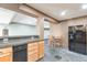 Basement kitchenette with granite countertops and black appliances at 6183 Buffalo Run, Littleton, CO 80125