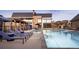 Resort-style pool with lounge chairs and umbrellas at 5134 Cupule Trl, Castle Rock, CO 80104